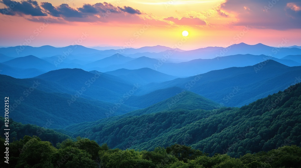 Obraz premium Scenic panoramic view of layered mountain ranges at sunset with vibrant colors