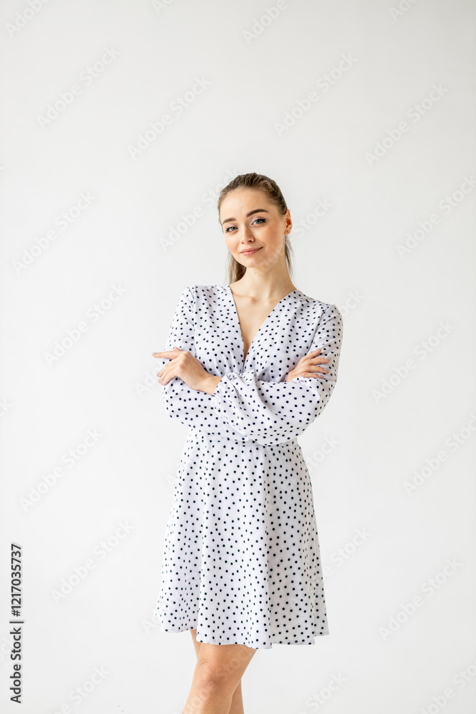 beautiful woman model posing in white polka dot dress in studio beautiful woman model posing in white polka dot dress in studio