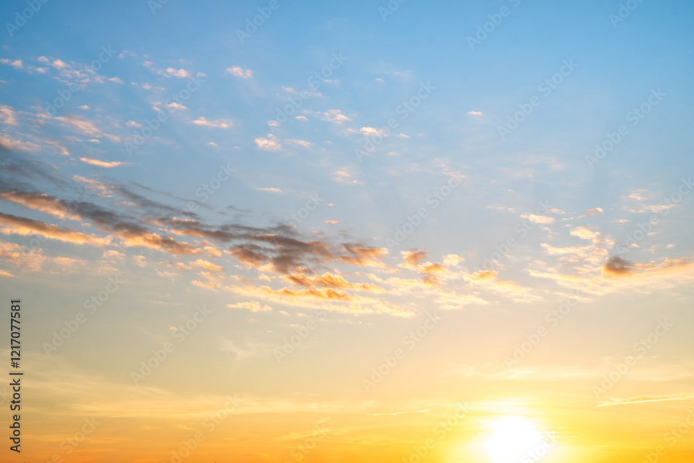 Fototapeta premium Sky,sunset, beautiful , luxury soft gradient orange gold clouds and sunlight on the blue sky perfect for the background, Sunrise on morning or everning in winter warm time ,Twilight summer,silhouette
