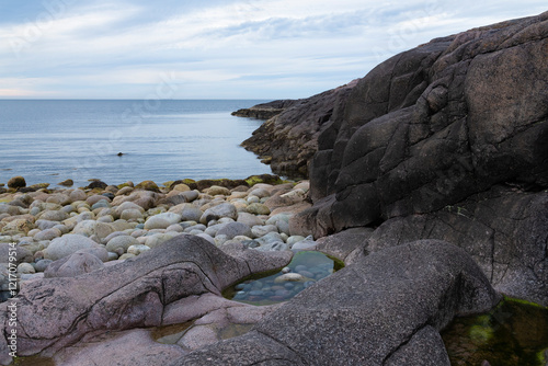 A rock on the shore of the Barents Sea on a cloudy July evening. Teriberka, Murmansk region, Russia photo