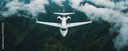 A sleek airplane flies above lush greenery and clouds, capturing the essence of luxury air travel in a scenic landscape. photo