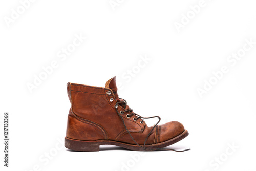 An old leather boot against a white background