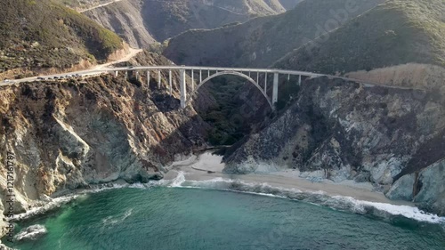 Aerial of the rugged coastline of Big Sur California. The Pacific Coast Highway and the famous Bixby Creek Bridge can be seen.