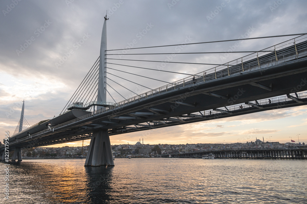 Sunset view of Halic Metro Bridge and cityscape of Istanbul with cloudy sky. Istanbul Turkiye Sunset view of Halic Metro Bridge and cityscape of Istanbul with cloudy sky. Istanbul Turkiye