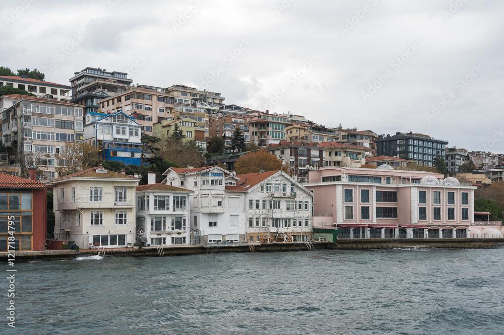 Fototapeta premium Beautiful view of the Bosphorus shore on a cloudy day, full of residential houses, Istanbul, Turkey.