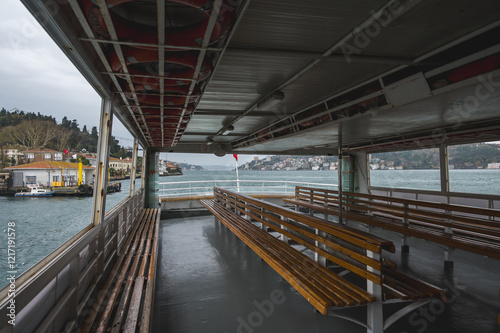 Amazing view of the Bosphorus and full of residential houses from the deck of a ferry at sunset, Istanbul, Turkey.