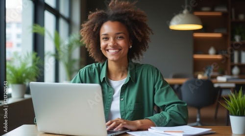 Smiling young woman working remotely on laptop.

Happy freelancer enjoying work in modern office.

Confident businesswoman working on her laptop.

