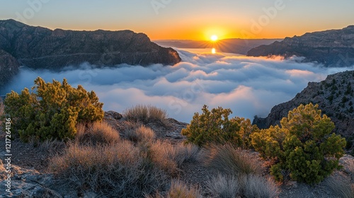 Sunrise over valley shrouded in clouds, mountaintop view photo