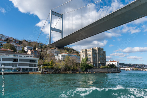 Beautiful view of the Bosphorus shore and Fatih Sultan Mehmet Bridge on a sunny day, full of residential houses, Istanbul, Turkey.