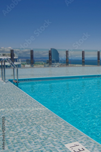 Outdoor infinity swimming pool onboard modern luxury cruiseship cruise ship liner with turquoise water under summer cloud sky photo