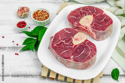 Raw ossobuco beef meat with spices and fresh herbs. Veal shank steak, traditional Italian ingredient