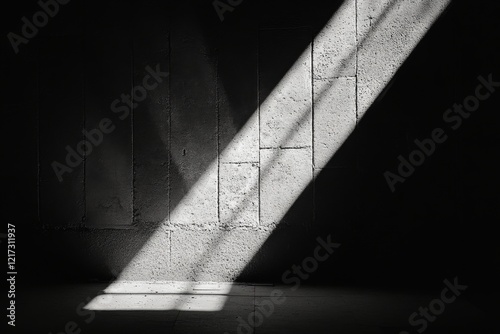 Light rays stream through an open door creating a dramatic contrast in a dark...