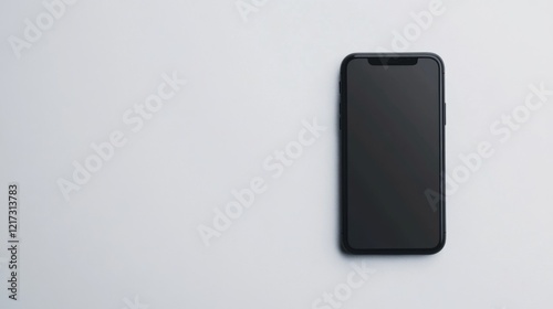 A sleek smartphone lying on a minimalist white surface, showcasing modern technology design photo