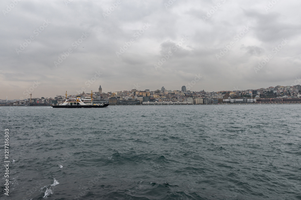 Beautiful view of the Bosphorus shore and Galata tower on a cloudy day, full of residential houses, Istanbul, Turkey. Beautiful view of the Bosphorus shore and Galata tower on a cloudy day, full of residential houses, Istanbul, Turkey.