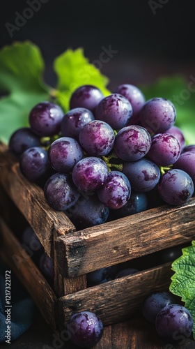 Freshly harvested grapes in a rustic wooden crate with green leaves
