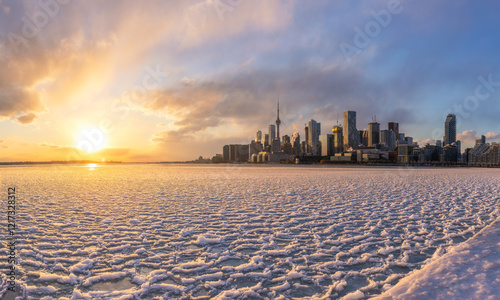 Lake Ontario frozen with pancake ice during a polar vortex. Sunset over the Toronto skyline