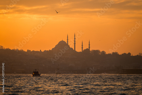Beautiful view of the Bosphorus and the mosque in the background at sunset. View of Fatih district photo
