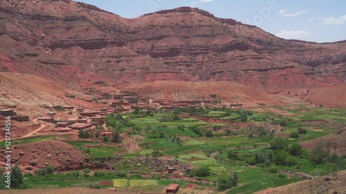 green valley village in morocco red mountains landscape