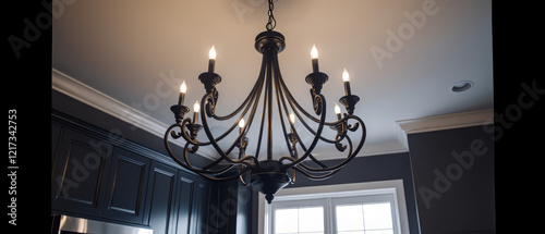 A wide-angle shot of a contemporary chandelier with gold and beige accents, hanging from a high ceiling in a luxury master bedroom