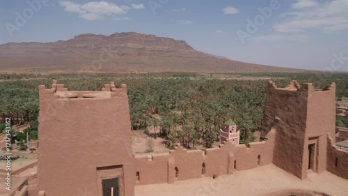 morrocan kasbah in palm valley of draa in desert oasis