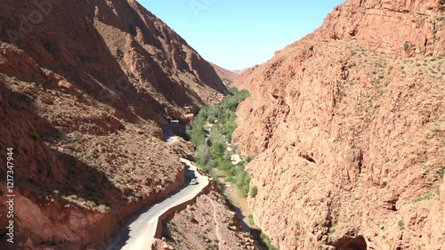Vehicle traveling along winding road in the valley and Dades gorge canyon in the mountains of Morocco