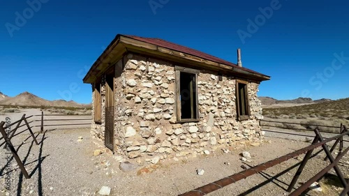 Remarkably intact miner's cabin stands as a time capsule in the haunting Rhyolite ghost town near Death Valley, offering a poignant glimpse into the harsh yet hopeful lives of Gold Rush era prospector