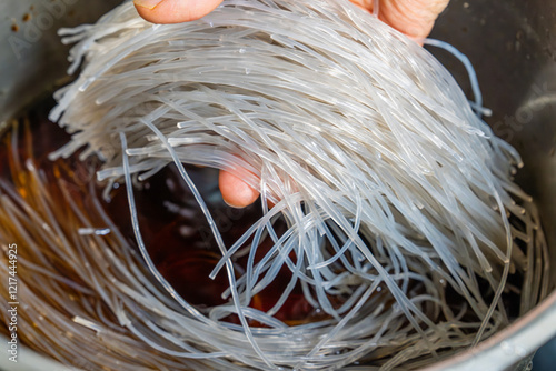 braising glass noodles with soy sauce in the pot photo