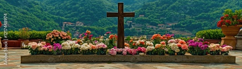 Hillside grave with colorful flowers, cross, peaceful background.  Memorial photo