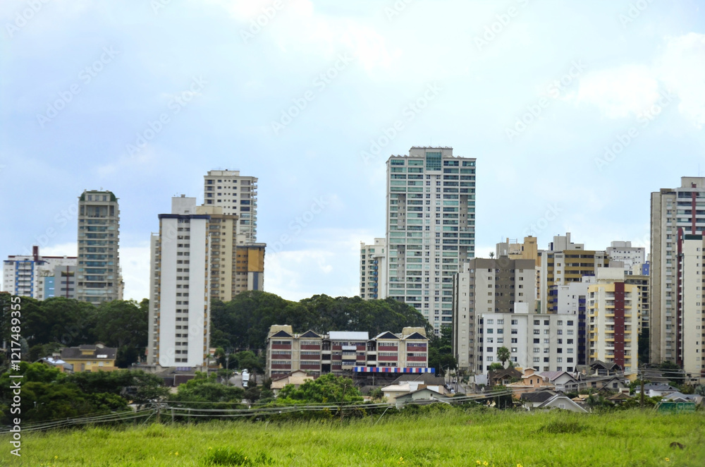View of the green line of residential and commercial buildings in the Jardim Aquárius neighborhood, west of the city of São José dos Campos on a cloudy day View of the green line of residential and commercial buildings in the Jardim Aquárius neighborhood, west of the city of São José dos Campos on a cloudy day