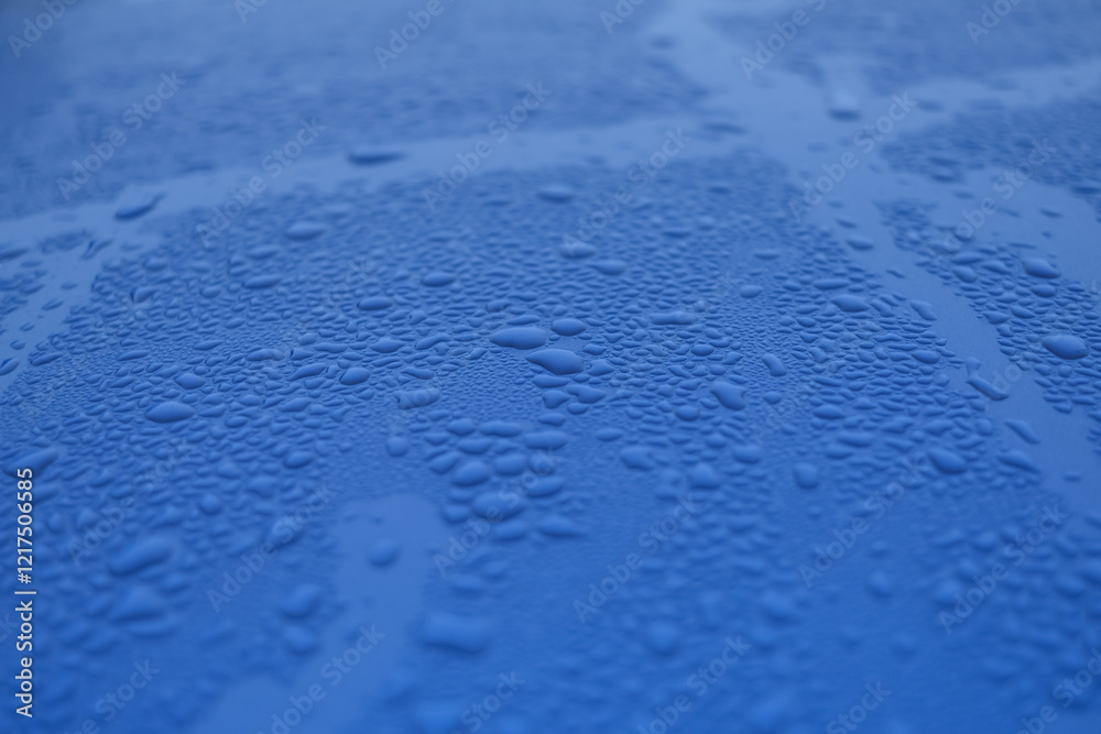 A blue surface with many small water droplets on it A blue surface with many small water droplets on it