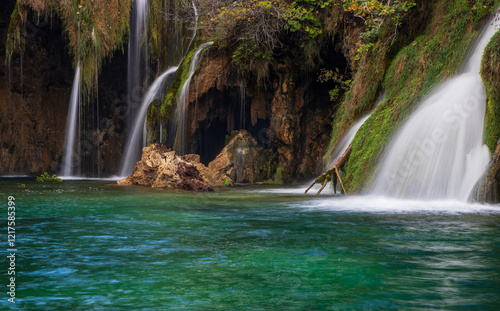 A collection of cascading waterfalls hidden within the dense forest