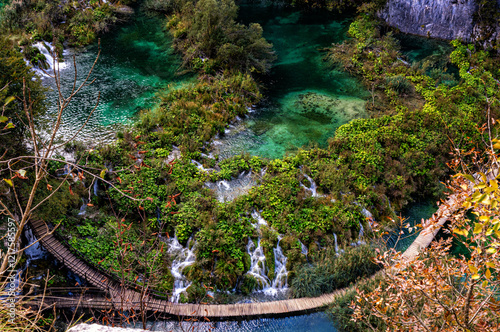 A mesmerizing aerial view of cascading Waterfalls and Wooden Pathway