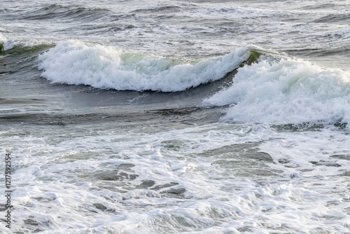 Breaking Ocean Waves at Seaside Shore with White Foam and Spray - Concept of Power, Force, Change, Washing Away, Fleeting Life Experience photo