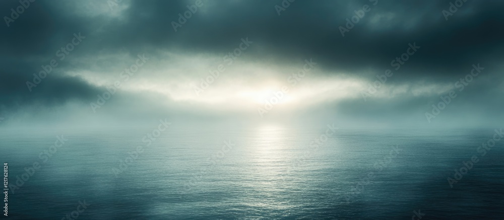 Obraz premium Misty ocean landscape with moody clouds and soft light reflections on water surface Copy Space