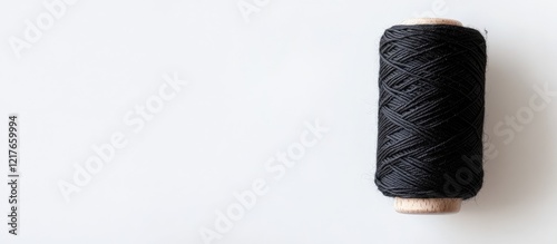 Black Yarn Spool Isolated on White Background with Ample Copyspace for Creative Text or Design Use photo