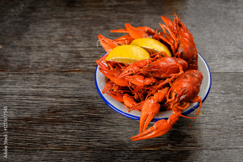 crayfish boiled with lemon on a wooden background