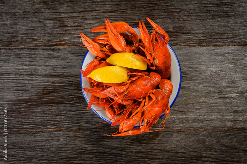 crayfish boiled with lemon on a wooden background