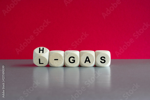 Symbol for the change from L-gas (low caloric) to H-gas (high caloric) until 2030 in Germany. Wooden cubes, red background. photo