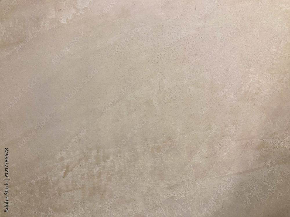 Fototapeta premium Close-up image of a textured stone or concrete surface, with natural color variations and a sense of depth from an angled view The focus is on the texture and play of light