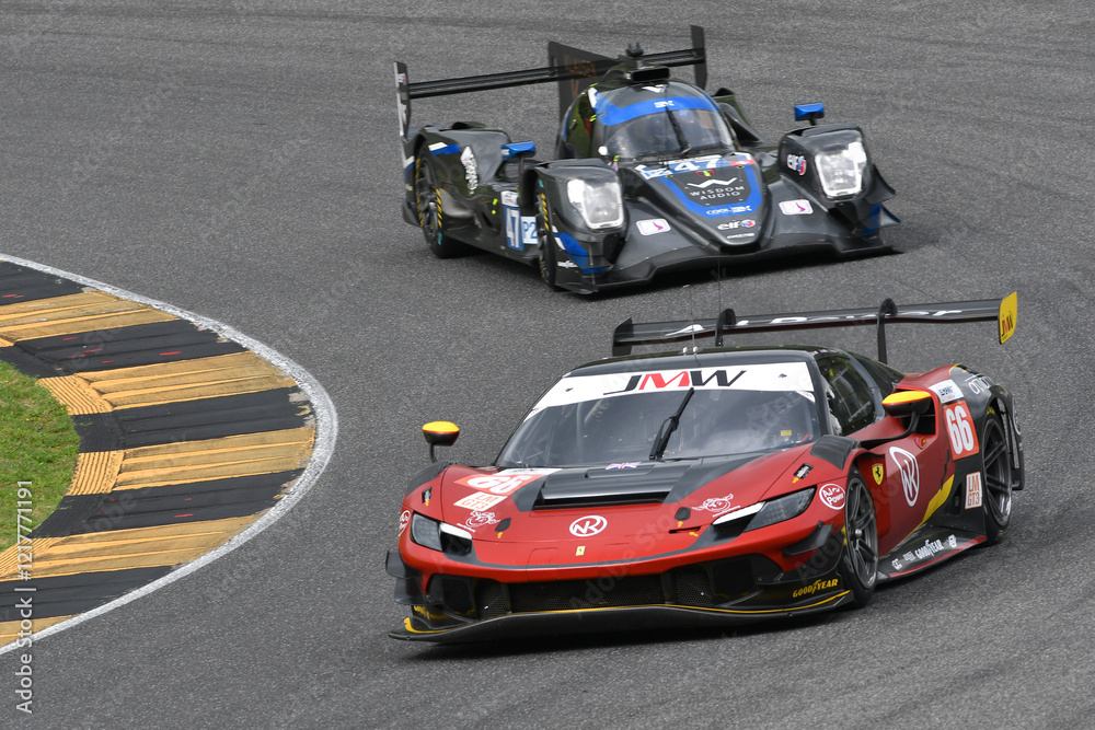 Fototapeta premium Scarperia, Italy - September 29th 2024: Ferrari 296 LMGT3 of team JMW MOTORSPORT drive by NOBLE-HART-TUCK in action during 4h of Mugello.