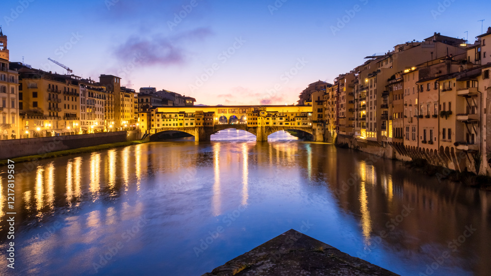 Ponte Vecchio bridge acros arn river .Only surviving bridge from world war 2 glowing in morning sun light and colorful sky, Florence Italy Ponte Vecchio bridge acros arn river .Only surviving bridge from world war 2 glowing in morning sun light and colorful sky, Florence Italy
