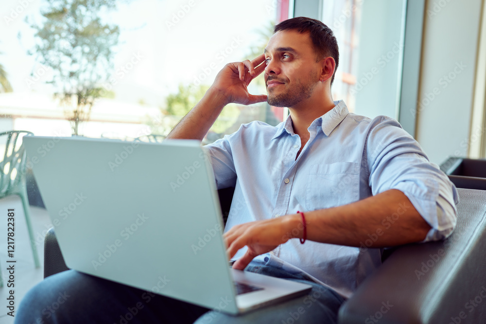 Businessman using laptop computer in office, taking a break and looking out the window, thinking about future opportunities Businessman using laptop computer in office, taking a break and looking out the window, thinking about future opportunities