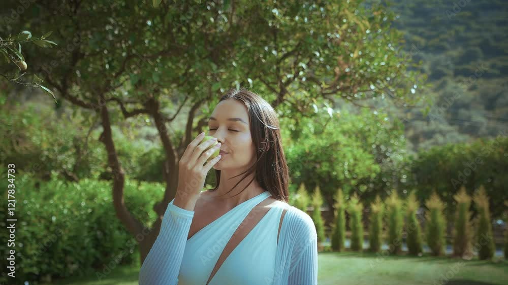 Beautiful European woman picking lemons in a garden, enjoying the natural aroma of fresh fruit. Beautiful European woman picking lemons in a garden, enjoying the natural aroma of fresh fruit.
