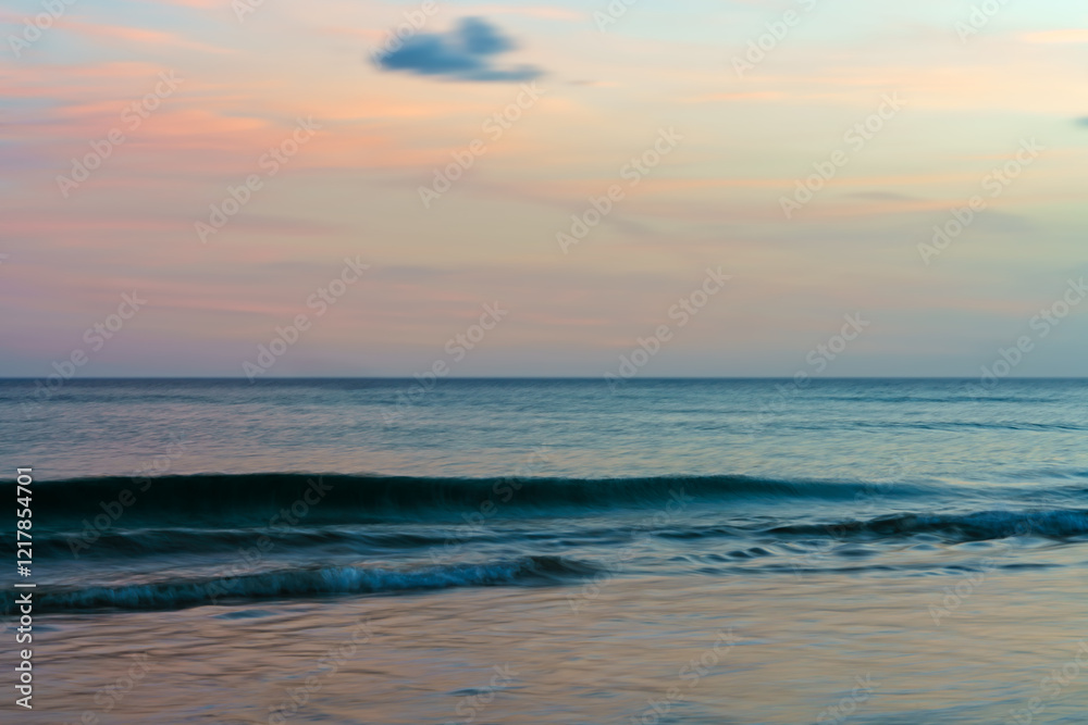 Fototapeta premium Evening ocean scene with gentle waves and a serene horizon.