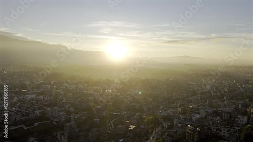Beautiful sunrise over Kathmandu, Nepal city - Aerial 4K HDR drone footage of Kathmandu Valley urban sprawl with bright early morning sun.