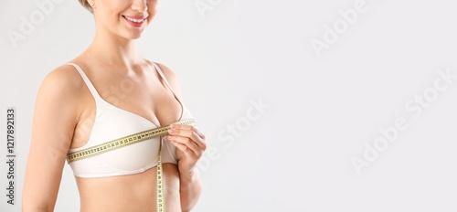Beautiful young woman measu...
