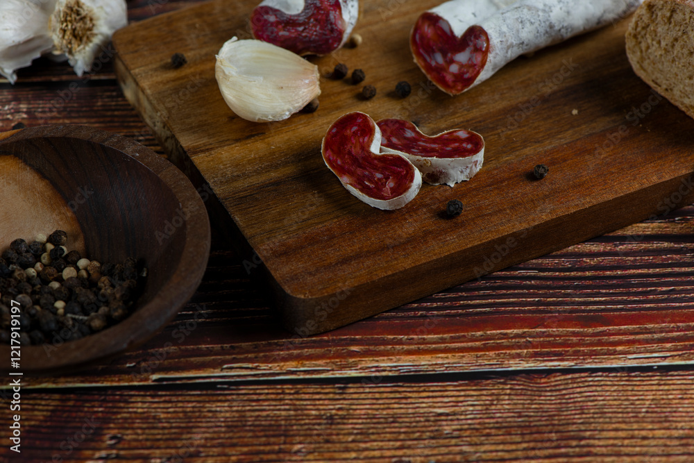 Marble cutting board with sliced salami on it Marble cutting board with sliced salami on it