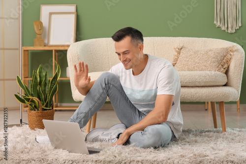 Young man with laptop video...