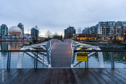 Pedestrian Bridge at Dusk with Urban Skyline in False Creek, Vancouver, BC photo