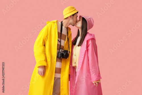 Young couple in raincoats k...
